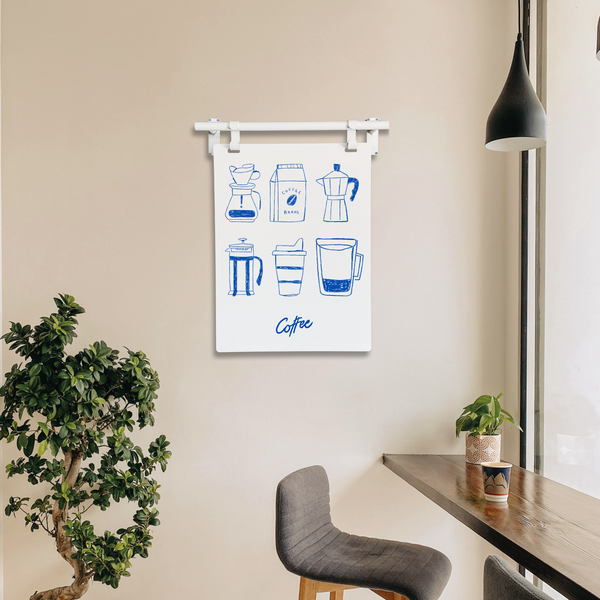 Wall art with coffee-themed illustrations in a modern kitchen setting.