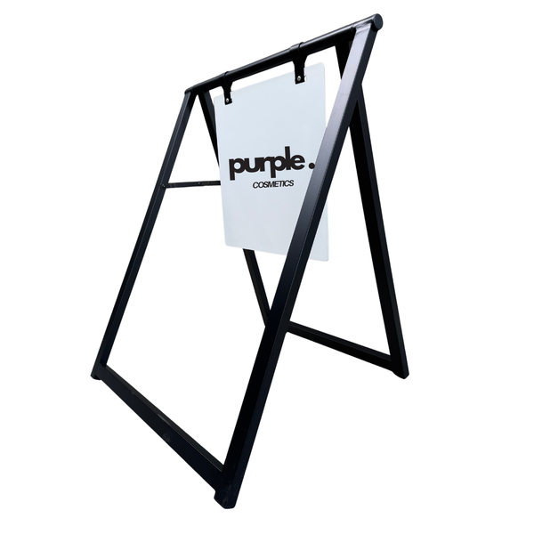 Black metal stand with a white sign displaying 'purple.cosmetics' on a white background