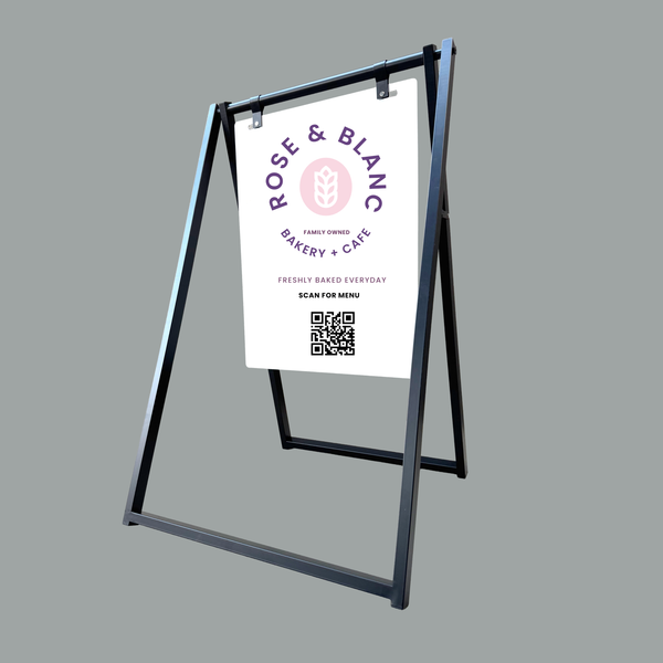 A-frame sign with Rose & Blanc Bakery & Cafe logo on a gray background