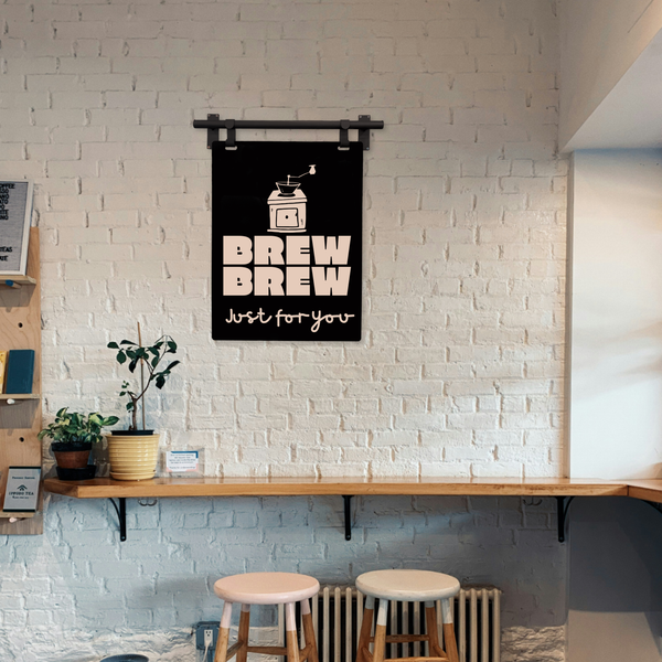 brew brew coffee art design with hanging frame in a coffee shop environment