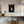 black abstract coffee artwork design with hanging frame in a modern interior setting