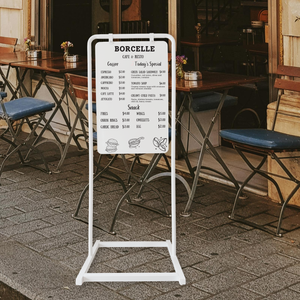 Outdoor cafe with a menu board displaying 'Borcelle' menu on swing sign