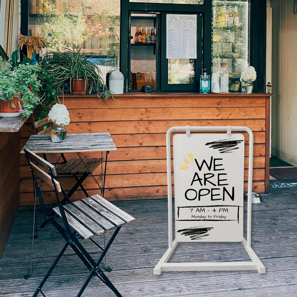 Pop-up coffee shop with a 'We Are Open' swing business display sign