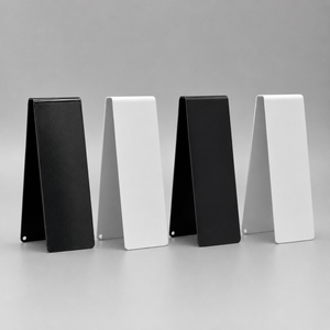 Four table number signs in 2 black and 2 white arranged in a row on a gray background