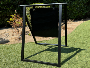 A black metal A-frame sign with a black magnetic board