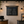 Bakery interior with a landscape hanging chalkboard menu displaying cookie and cake options.