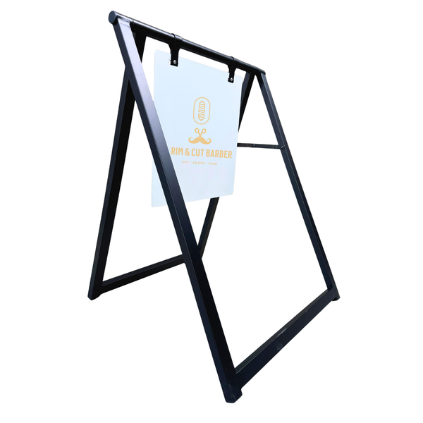 Black metal a-frame sign holder with a white sign attached on a white background