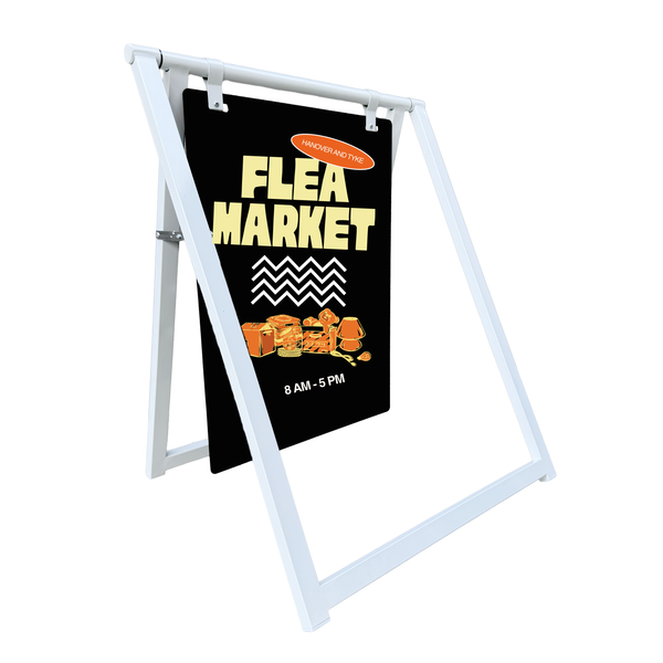 Flea market sign on a white stand with a black background and yellow text.