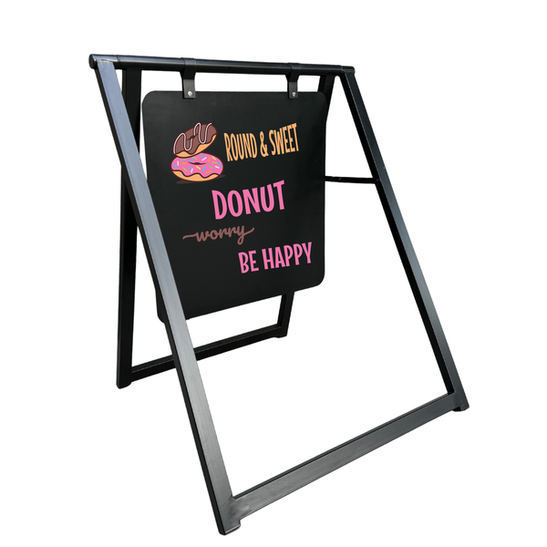 Black chalkboard with colorful text and donut illustration on a stand against a white background