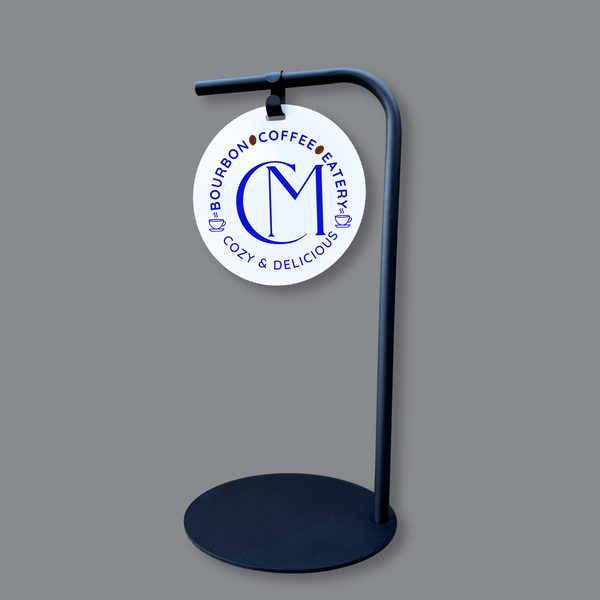 Round sidewalk sign with custom branding on a black stand 