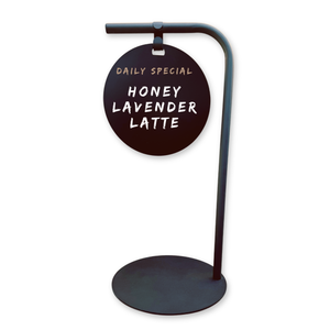 Black sidewalk round sign  displaying 'Daily Special Honey Lavender Latte' on a white background