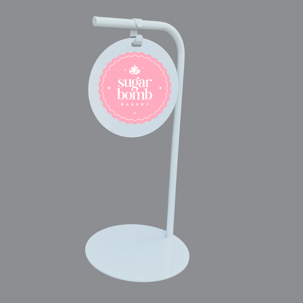 White retail sign with circular holder featuring 'sugar bomb' branding on a gray background