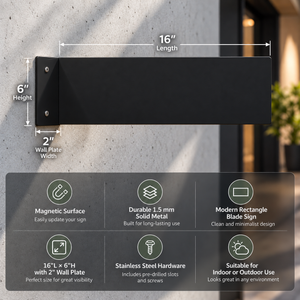 Black rectangular blade wall sign mounted on a textured wall, with dimension callouts showing 16 inches length, 6 inches height, and 2 inches wall plate width. A feature summary panel below highlights magnetic surface, solid metal construction, clean minimalist design, and suitability for indoor or outdoor use.