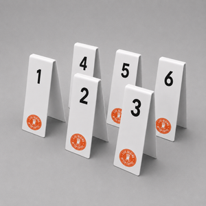 Set of six white table number sign with number 1-6 and red custom logos on a gray background