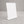 A minimalist tabletop metal sign holder with a built-in base, standing upright on a textured gray concrete surface against a neutral gray background.