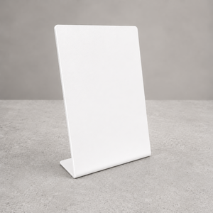 A minimalist tabletop metal sign holder with a built-in base, standing upright on a textured gray concrete surface against a neutral gray background.