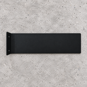 A front side black metal wall mount bracket with a flat rectangular panel and a left-side mounting flange, shown against a textured light gray concrete background.