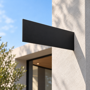A minimalist matte black rectangular wall-mounted blade sign mounted on a textured light gray concrete pillar