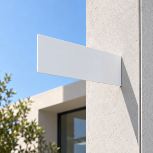 A minimalist, rectangular white wall-mounted blade sign shown mounted on a textured concrete pillar outdoors against a blue sky.