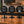 Three round black coffee shop round table signs displayed on a wooden counter in a cafe setting. The signs read 'BREW PICK UP HERE', 'BREW ORDER HERE', and 'BREW SCAN TO ORDER' with a QR code on the right.