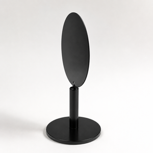 A minimalist black oval tabletop display in a side view