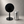 A minimalist black circular table sign shown next to a silver aluminum beverage in 12 oz  for a size reference.
