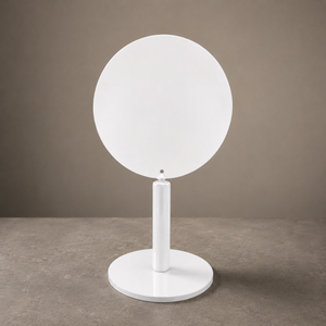 A modern white round tabletop stand with round base, set against a neutral brown studio background.