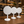 Three modern white circular tabletop stands arranged on a wooden counter in a cafe setting.