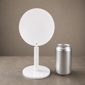 A minimalist white circular table sign shown next to a silver aluminum beverage in 12 oz  for a size reference.