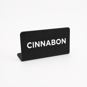 Black counter sign with 'CINNABON' text on a white background