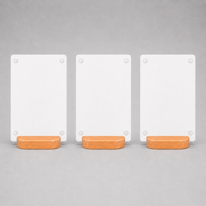 Three blank white rectangular tabletop menu sign each resting on a small rounded wood stand.