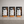 Three custom printed coffee shop menu display signs on wooden stands, displayed side-by-side on a gray countertop.