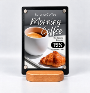A black metal vertical sign and a light wood stand, featuring a coffee advertisement for 'Larana Coffee' with a cup of coffee, a croissant, and a 15% discount offer.