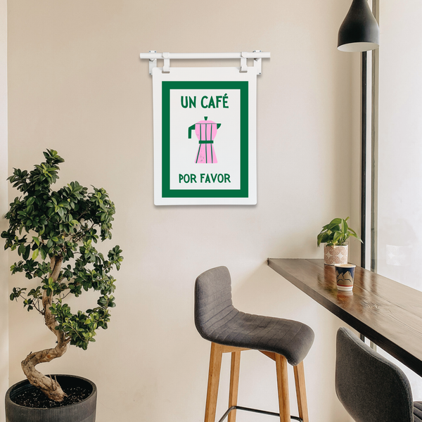 Modern interior with a plant, bar stools, and a coffee art sign on the wall.
